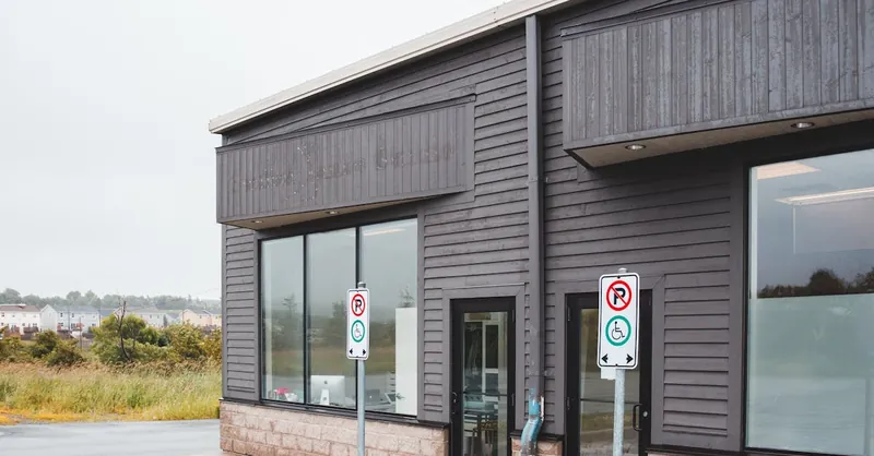 Contemporary suburban commercial building facade with signage and ample copy space.