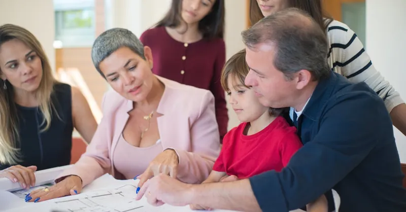 Family meeting with realtor to discuss house plans, emphasizing real estate decision-making.