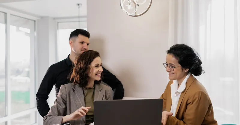 Professional real estate discussion in modern office setting with consultants and clients.