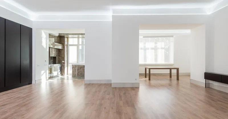 Bright and spacious empty room with wooden flooring, modern design, ideal for interior design inspiration.